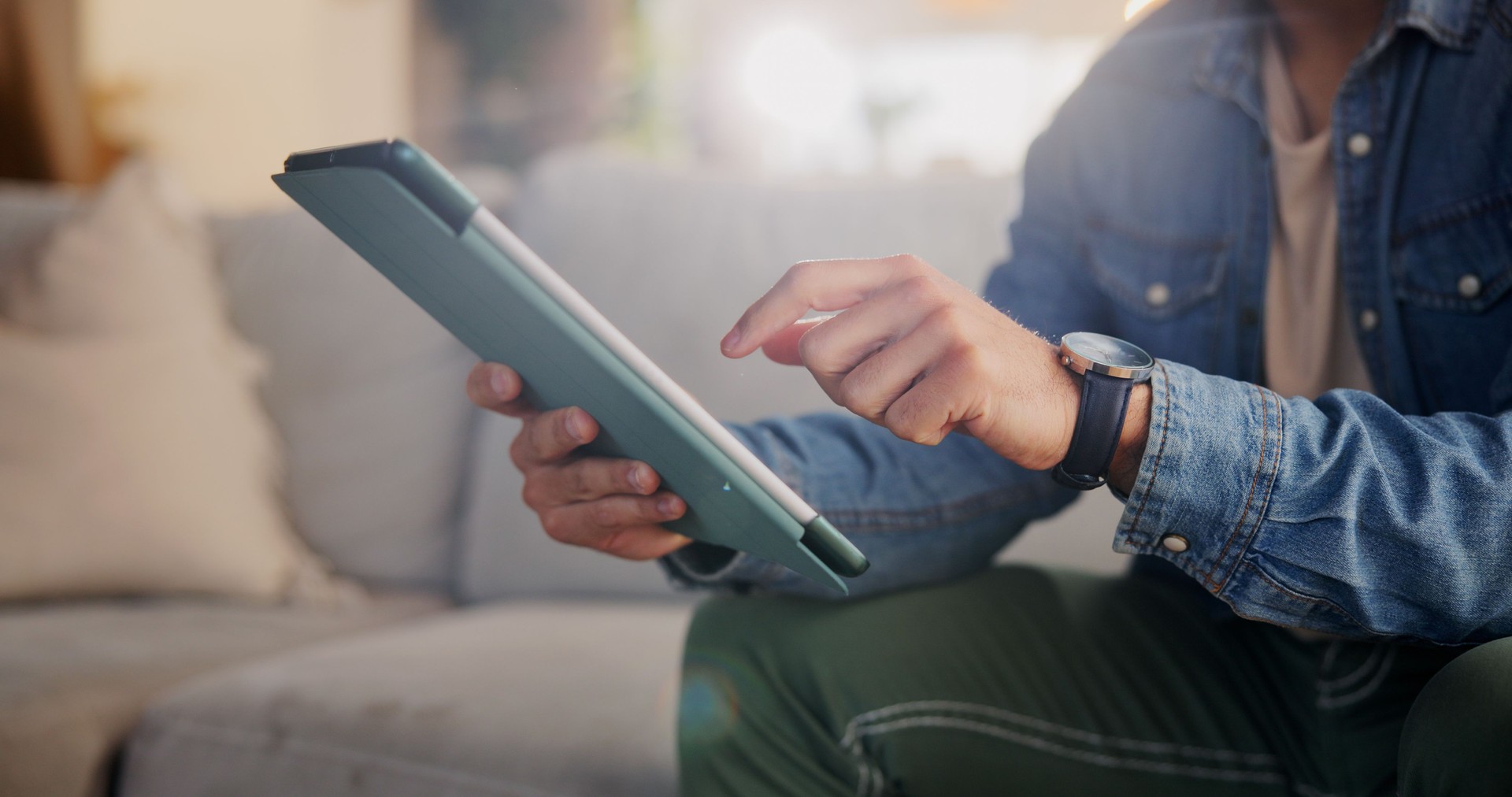 Home, sofa and hands with tablet for connection, streaming online and scroll for movie selection. Closeup, lounge and person with digital for application, check platform and social media in house